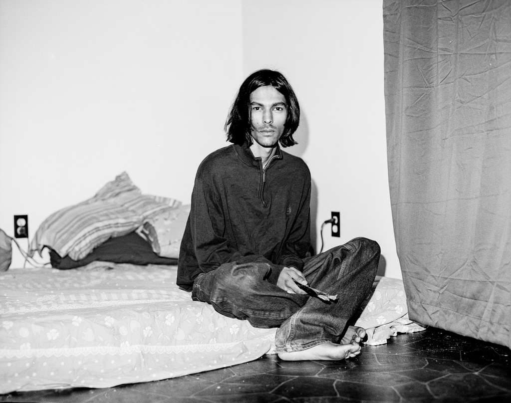 Sitting cross-legged on the floor of the studio
